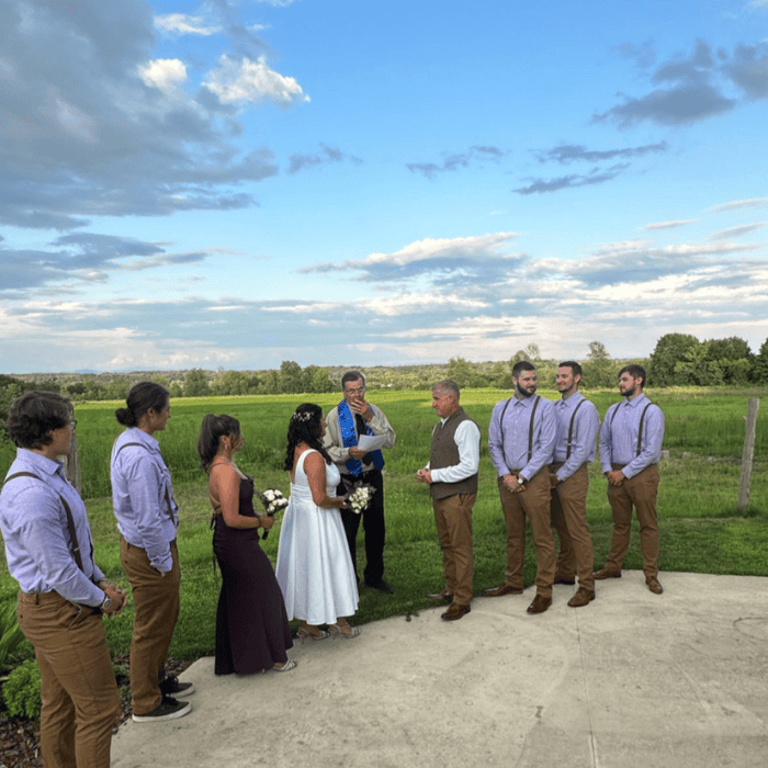 small marriage ceremony on the patio with blue sky and mountains in the background