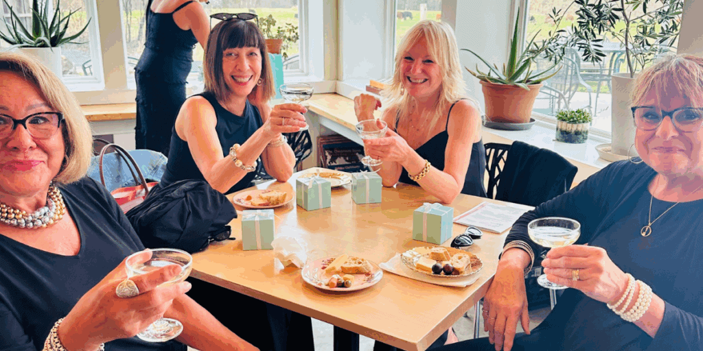 Women at a party raising a glass of prosecco